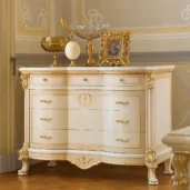 Princesse chest of drawers in carved wood with gold accents.