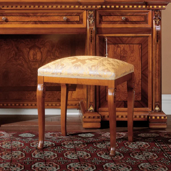 Handmade Regina wooden furniture with ornate design, featuring a luxurious upholstered stool and intricate cabinet details.