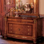 Luxurious handcrafted Senator dresser with intricate carvings, adorned with a floral arrangement.