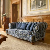 Luxurious handmade Senator sofa with blue damask upholstery in a luxury interior.